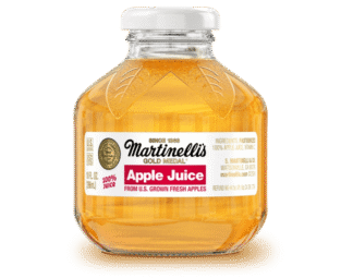 Martinelli's apple juice on black background