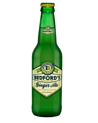 Refreshing ginger ale in green glass bottle