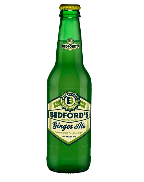 Refreshing ginger ale in green glass bottle