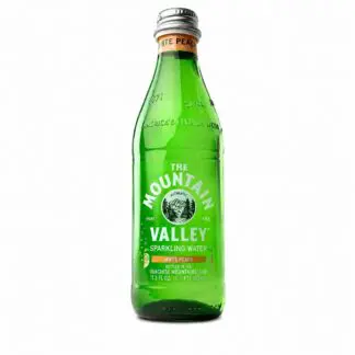 Green glass bottle of white peach sparkling water